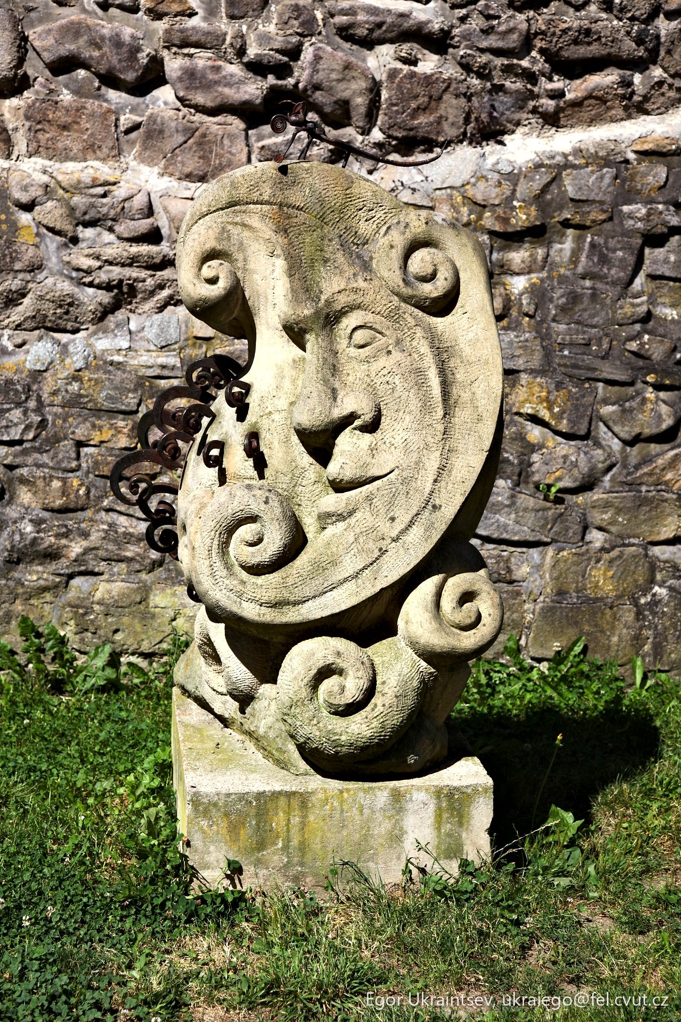Stone statue in front of a stone
