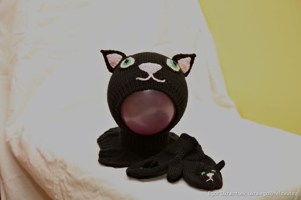 Stuffed cat on a bed