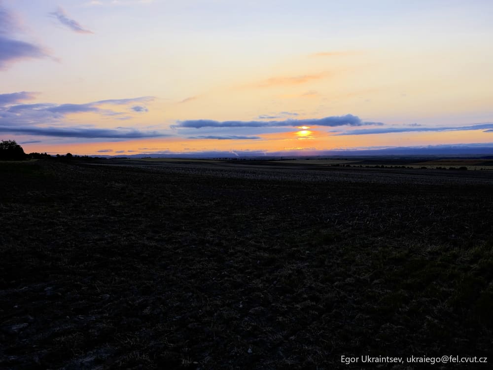 Sun setting over a field