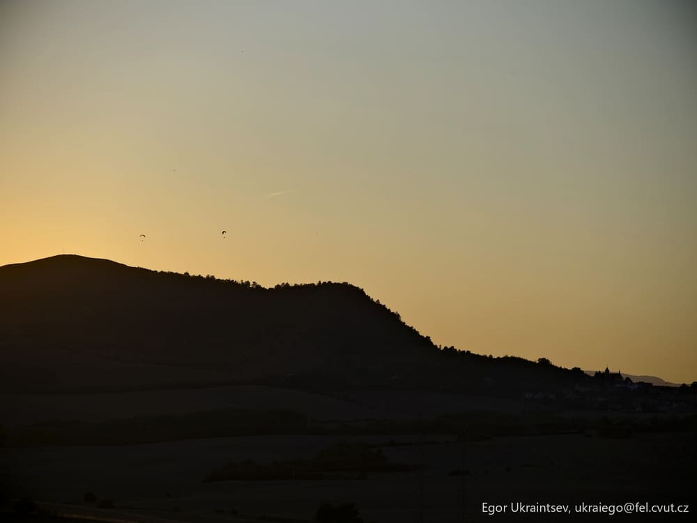 Plane flying over a hill