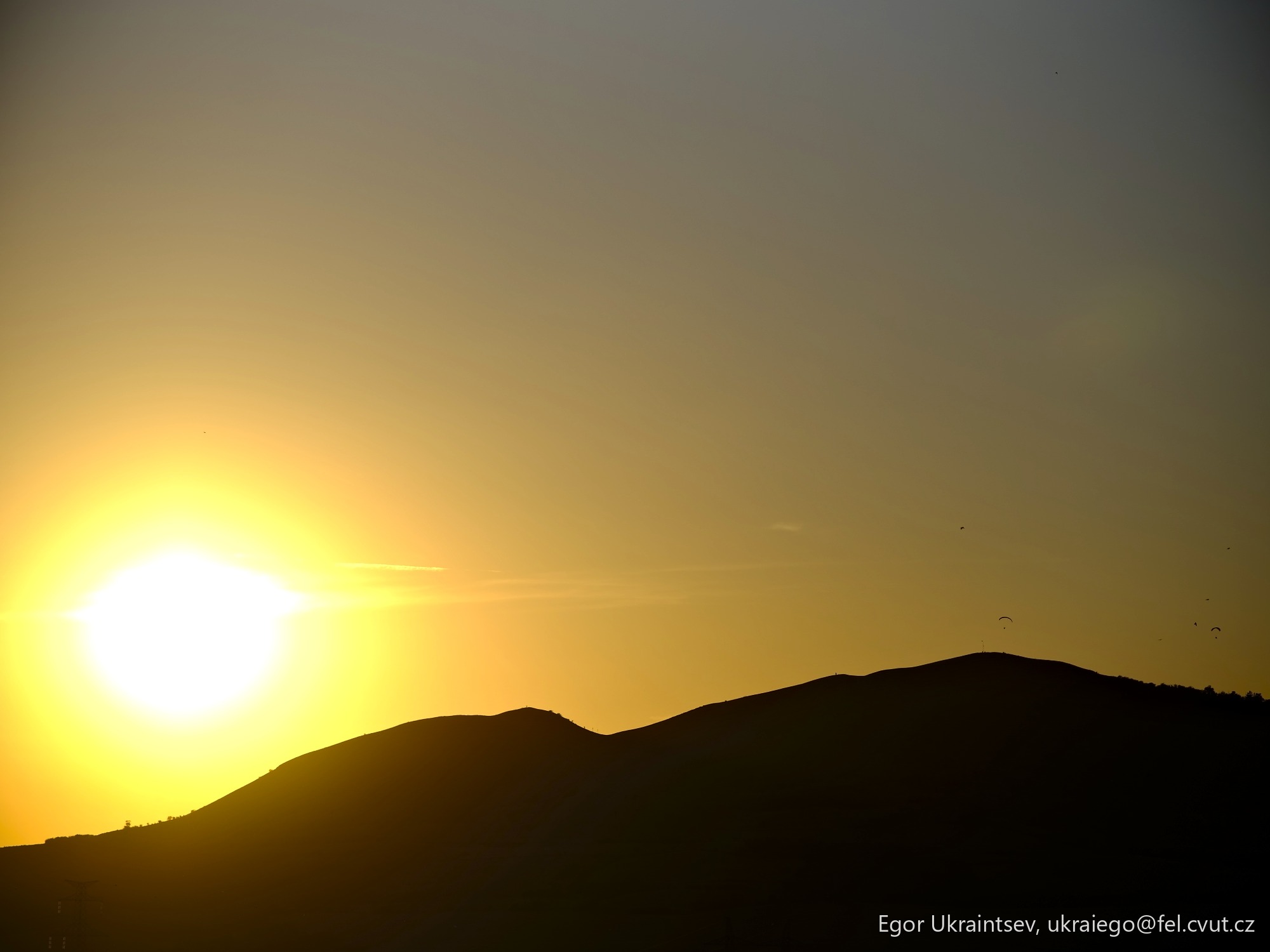 Sun setting behind a mountain