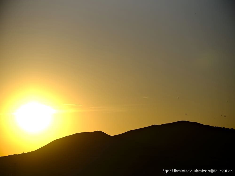Sun setting behind a mountain