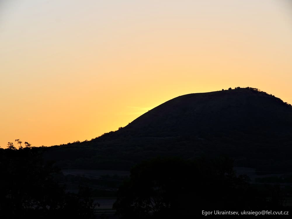 Sun setting behind a mountain
