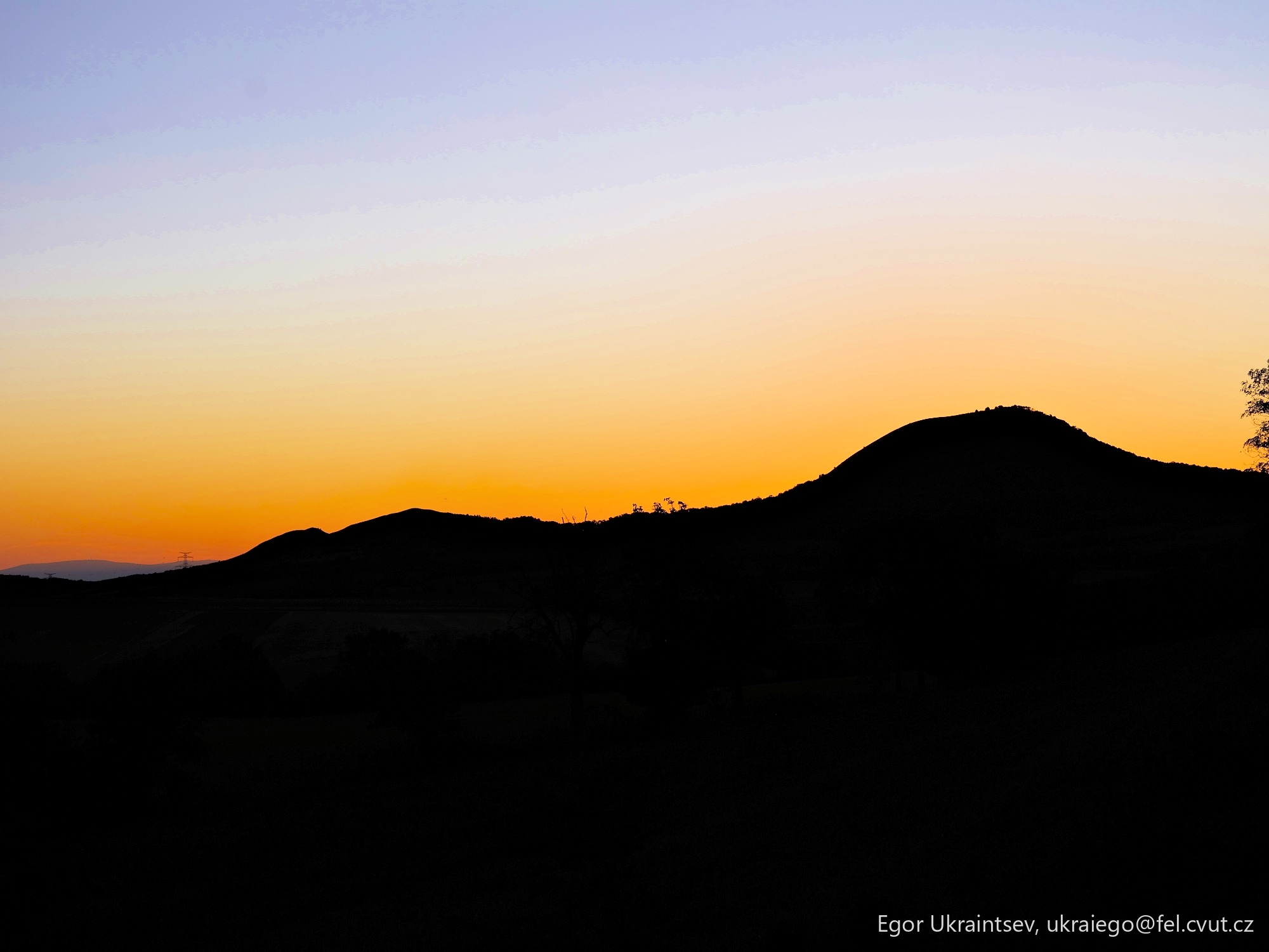 Sun setting behind a mountain