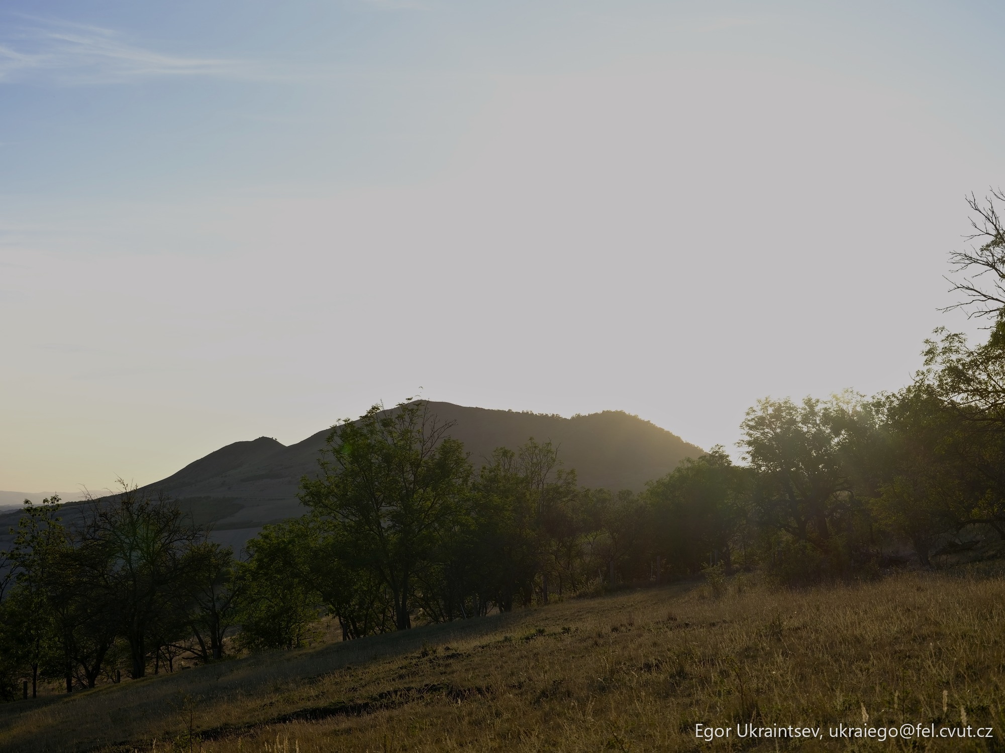 Sun setting behind a hill