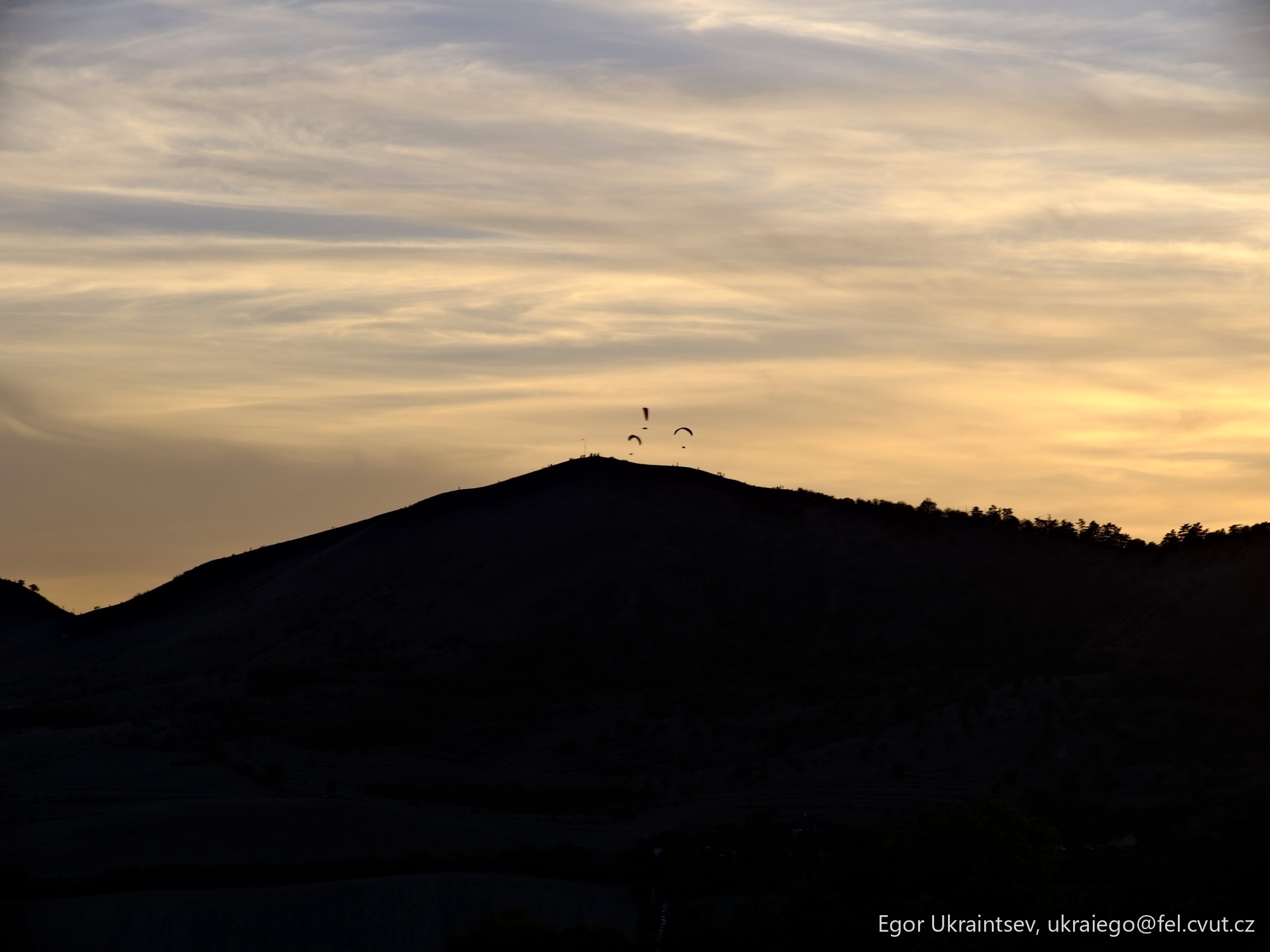 Sun setting behind a mountain