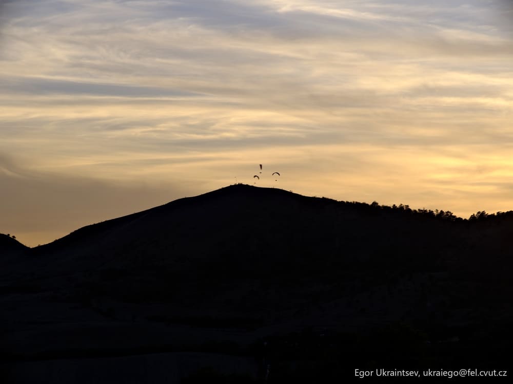 Sun setting behind a mountain