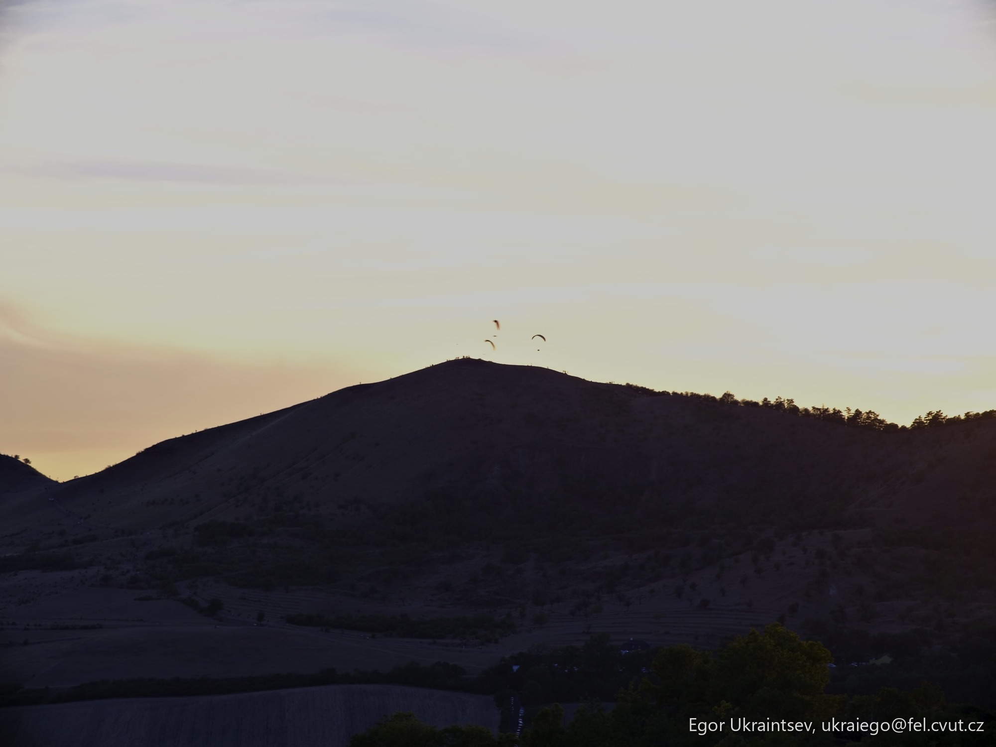 Sun setting behind a mountain