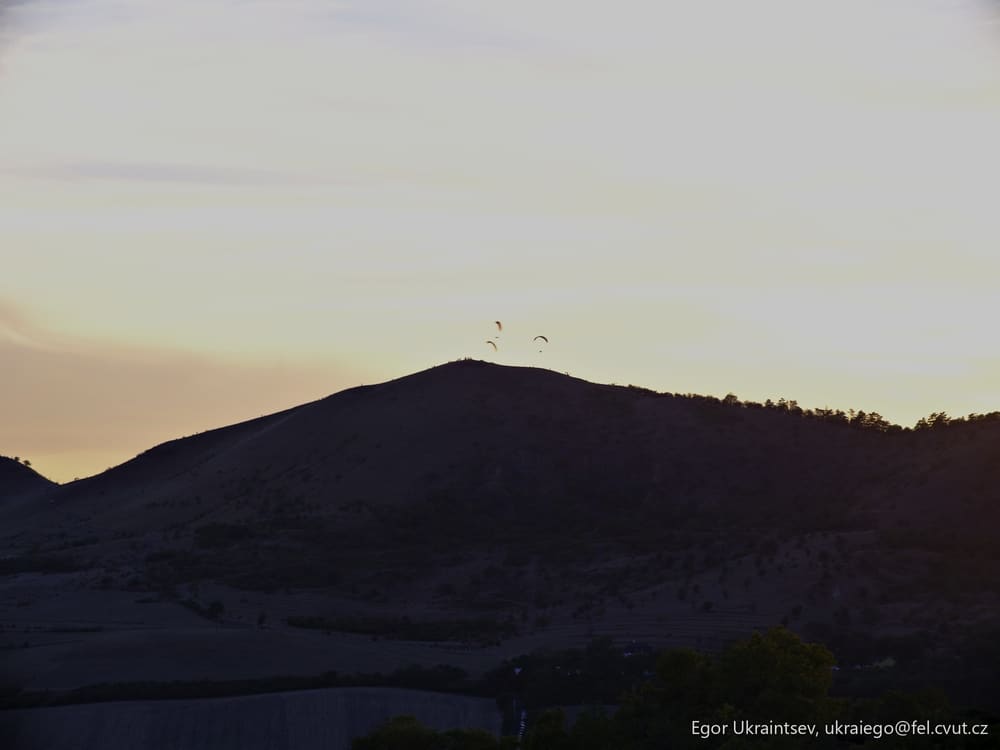 Sun setting behind a mountain