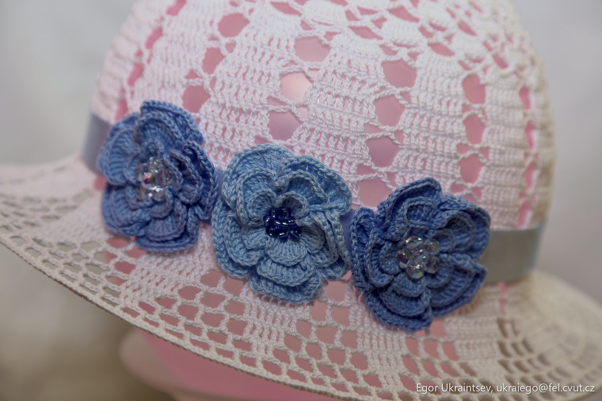 White hat with blue flowers