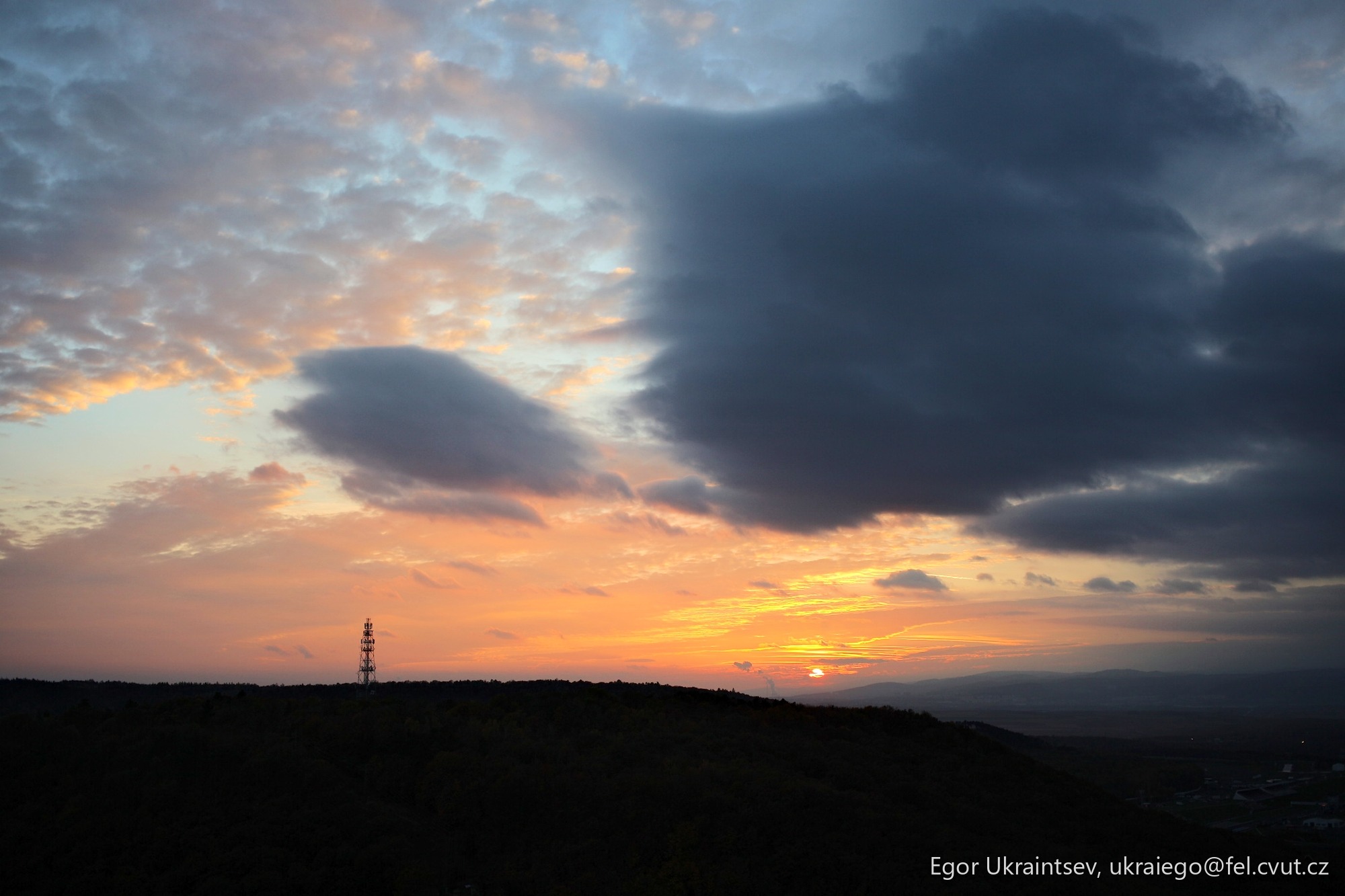 Sun setting over a hill