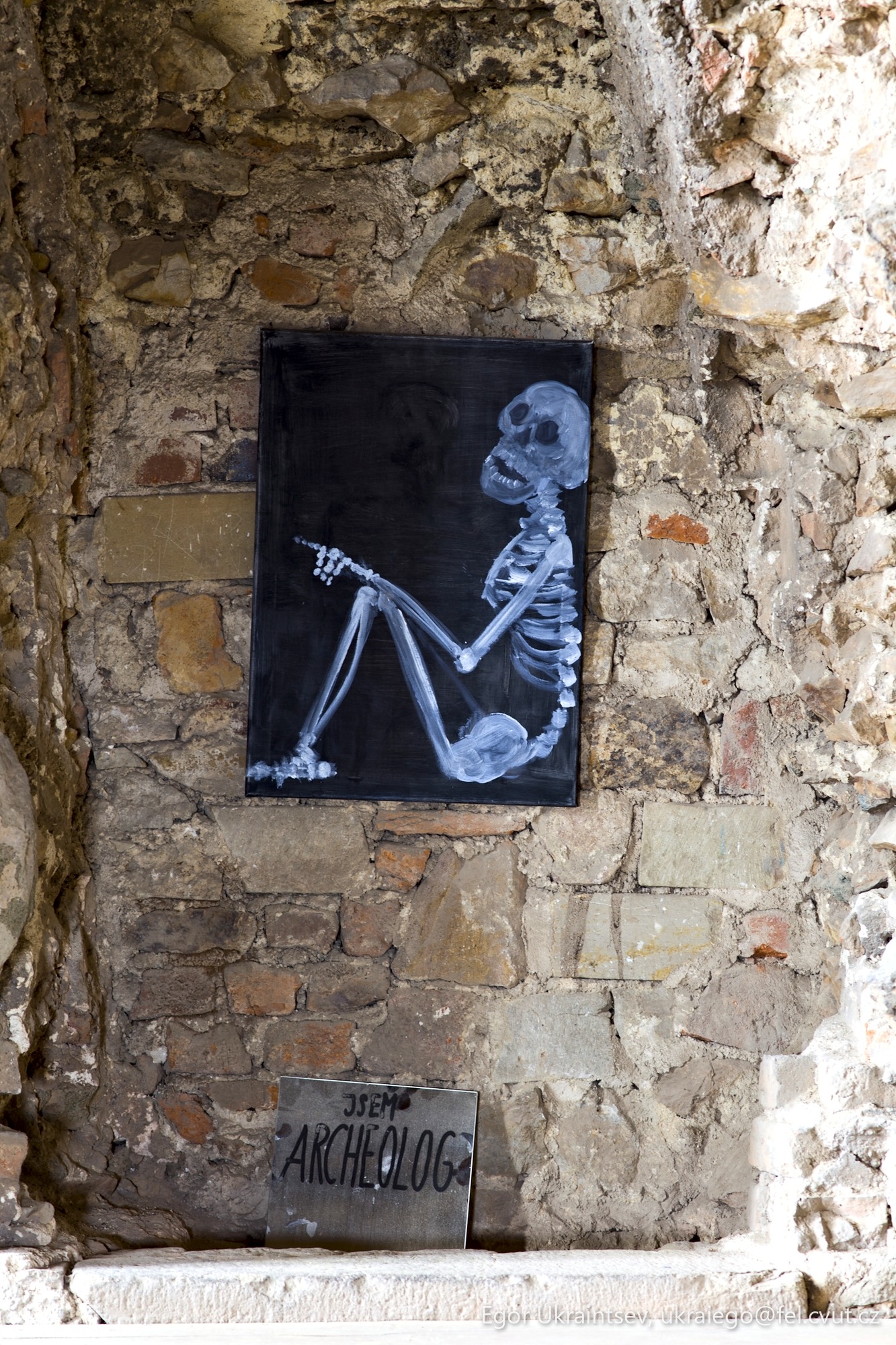 Skeleton on a stone wall