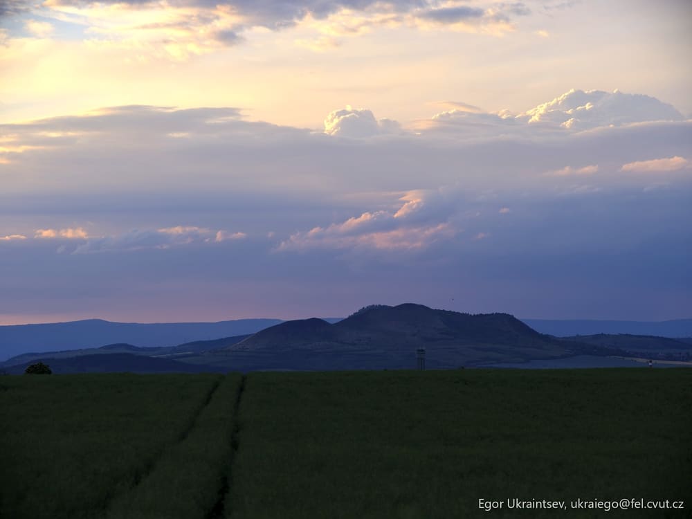 Grassy field with a mountain