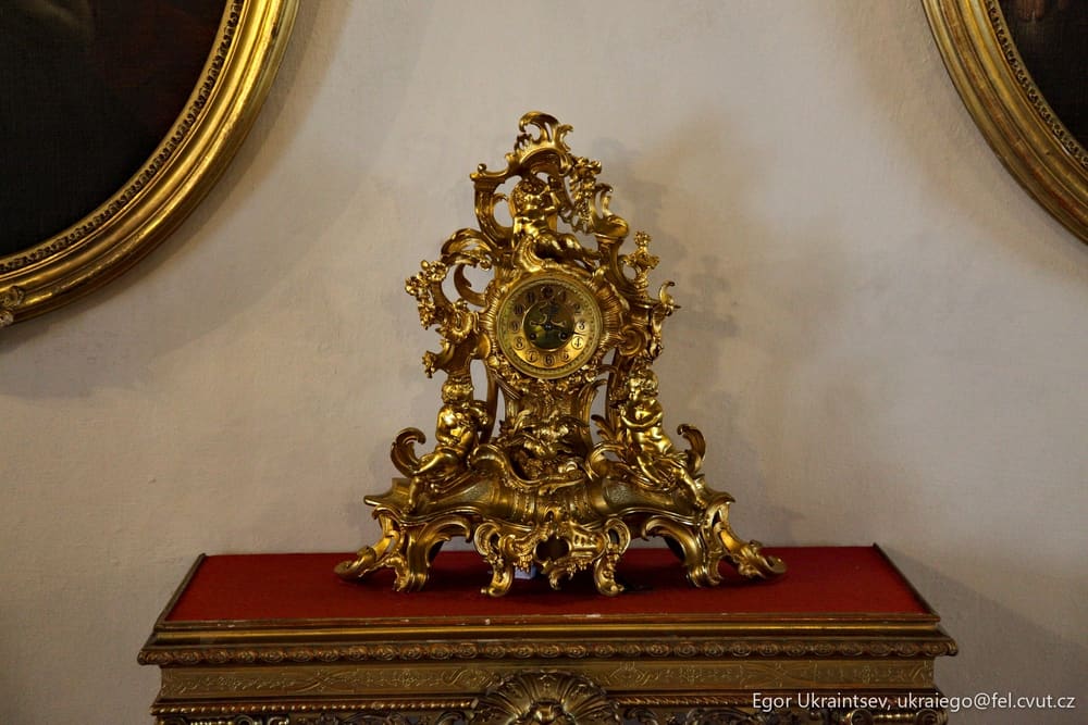 Gold clock on a red