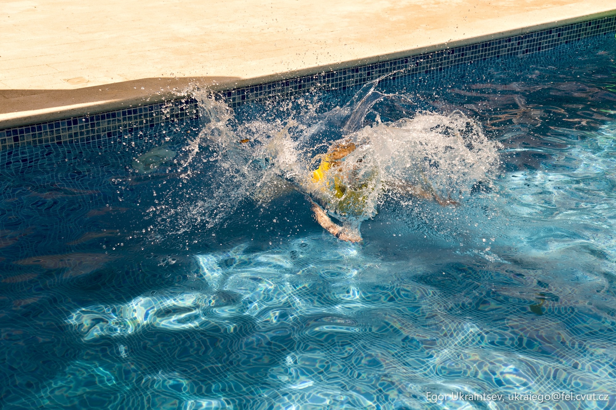 Boy jumping into a swimming
