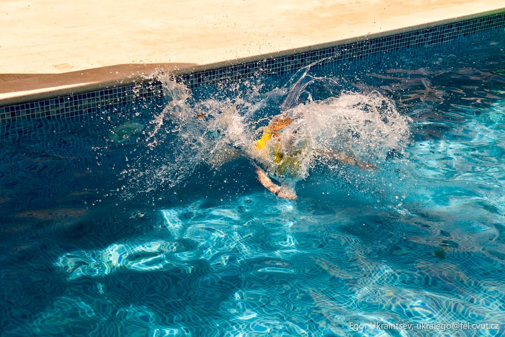 Boy jumping into a swimming