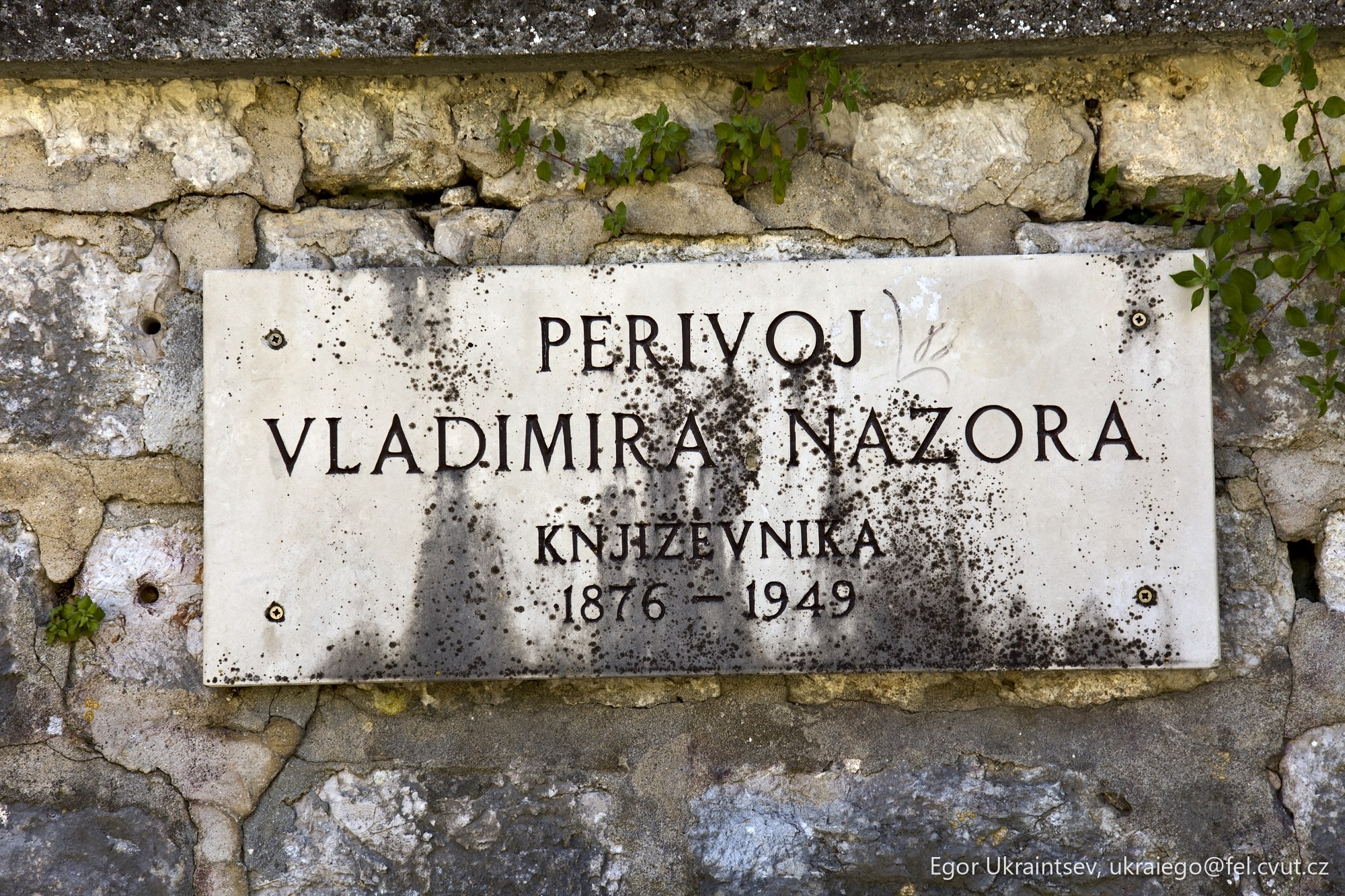 Sign on a stone wall