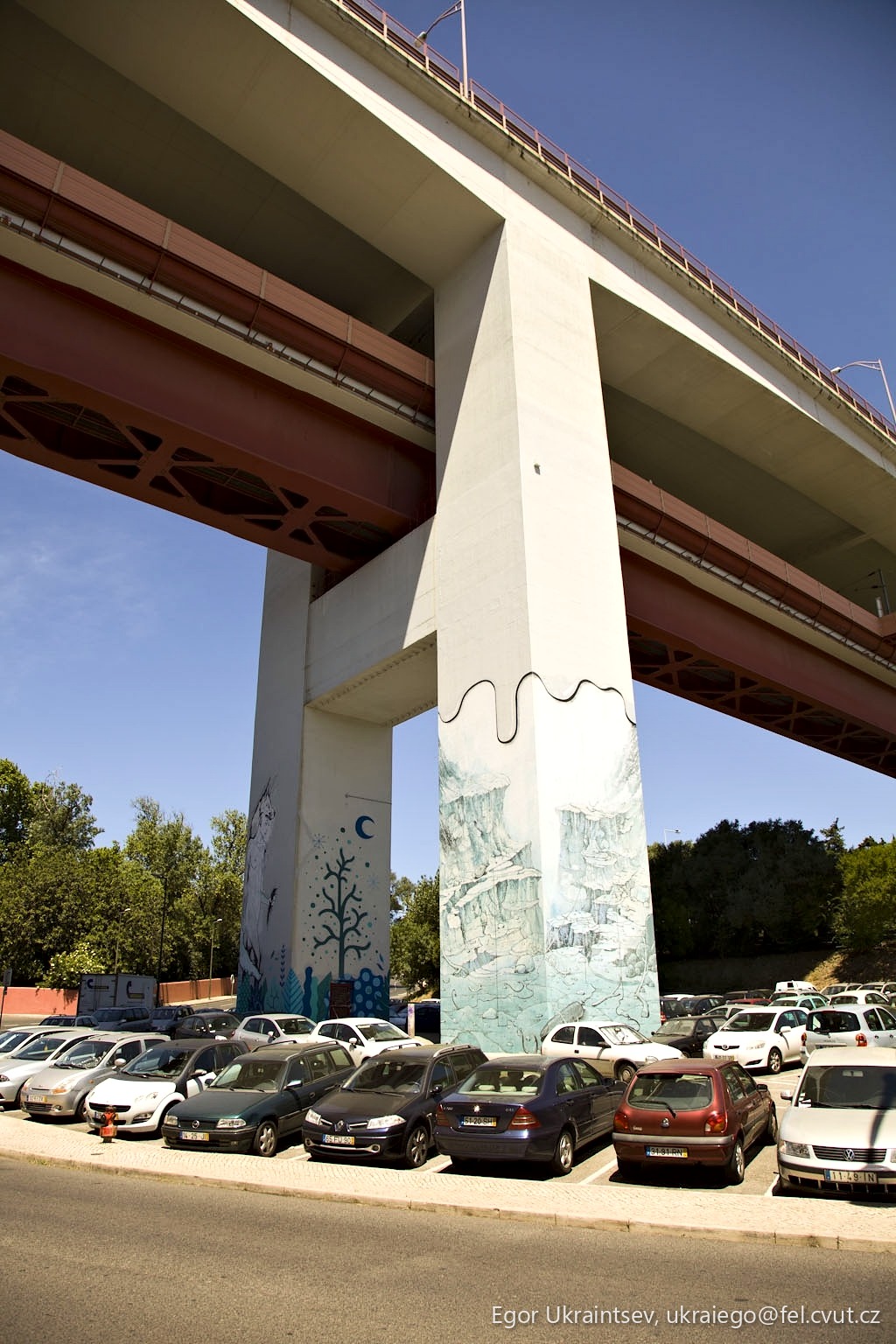 Cars parked under a bridge