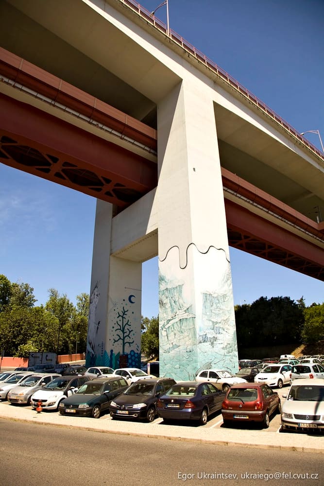 Cars parked under a bridge