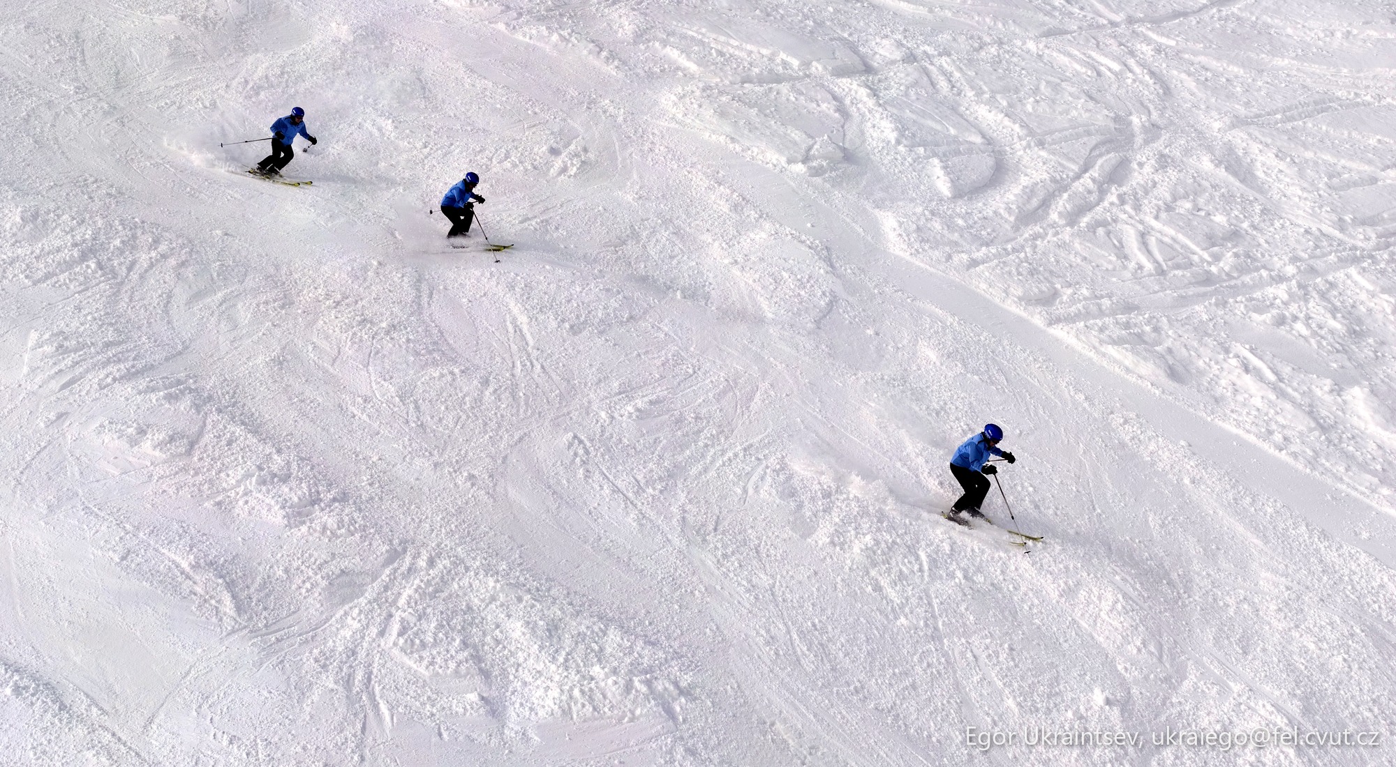 People skiing down a snowy