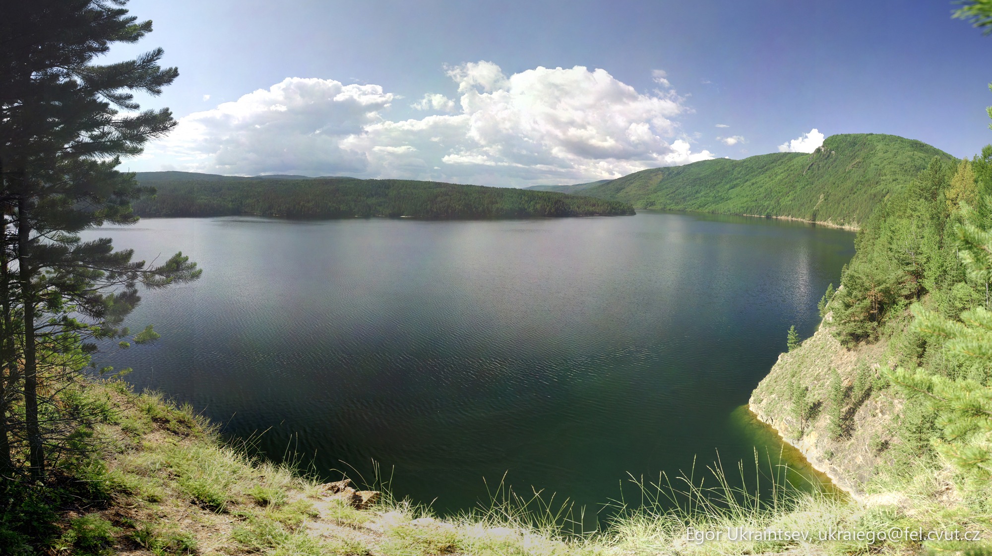 Lake surrounded by pine trees · P001 Phone 2011 08